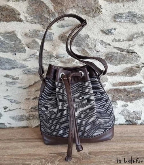 Brown ethnic bucket bag in Manjak woven loincloth