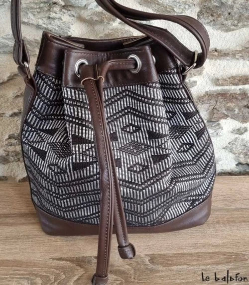 Brown ethnic bucket bag in Manjak woven loincloth