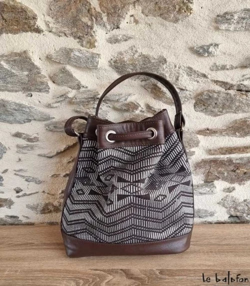 Brown ethnic bucket bag in Manjak woven loincloth